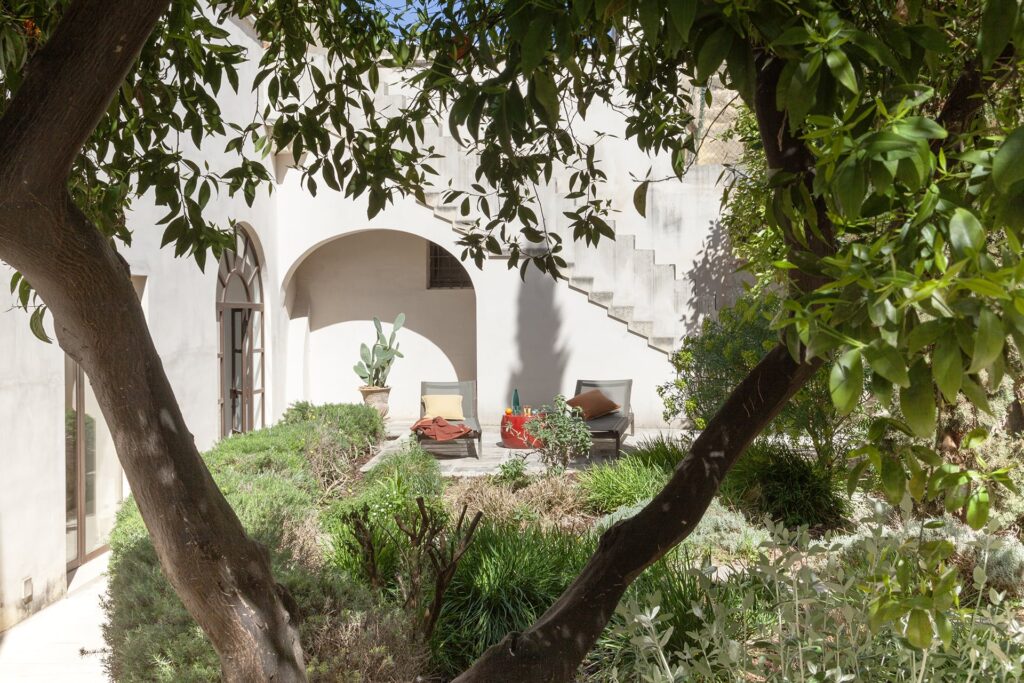Citrus garden with sun loungers and an external staircase, Agrumeto house, Nardò