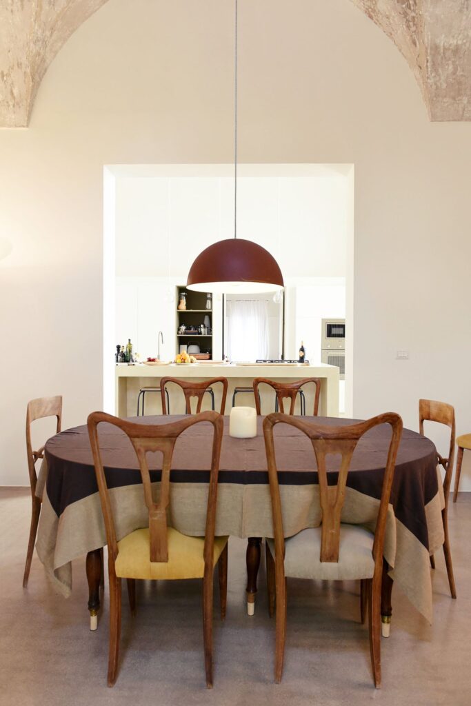 Dining room with dome pendant light and vaulted stone ceiling, La Corte, Nardò