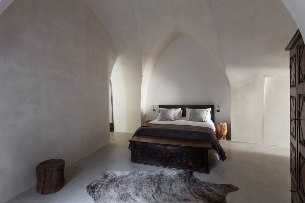 Bedroom 1 with dramatic vaulted ceiling and a fur throw, Agrumeto house, Nardò