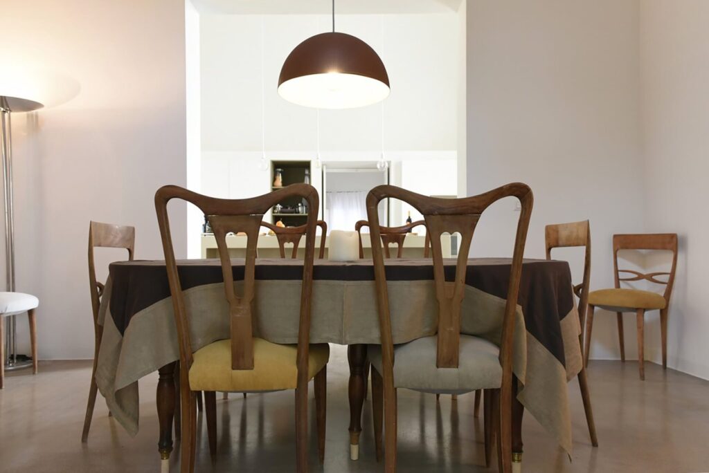 16. La Corte - NardòSalento - HORIZONTAL - Credit Elizabeth Rubino_6086_dining room_ Dining room with antique chairs and a large dome pendant light, La Casa Grande, Nardò
