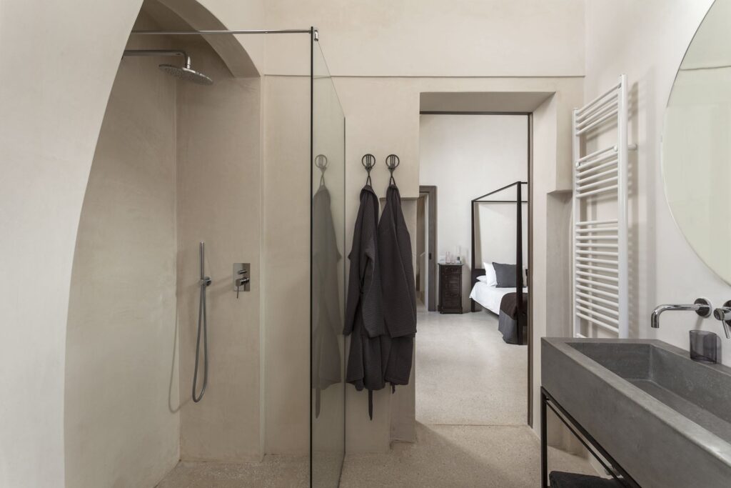 Walk-in shower and robes beside the master bedroom, Teatro house, Nardò