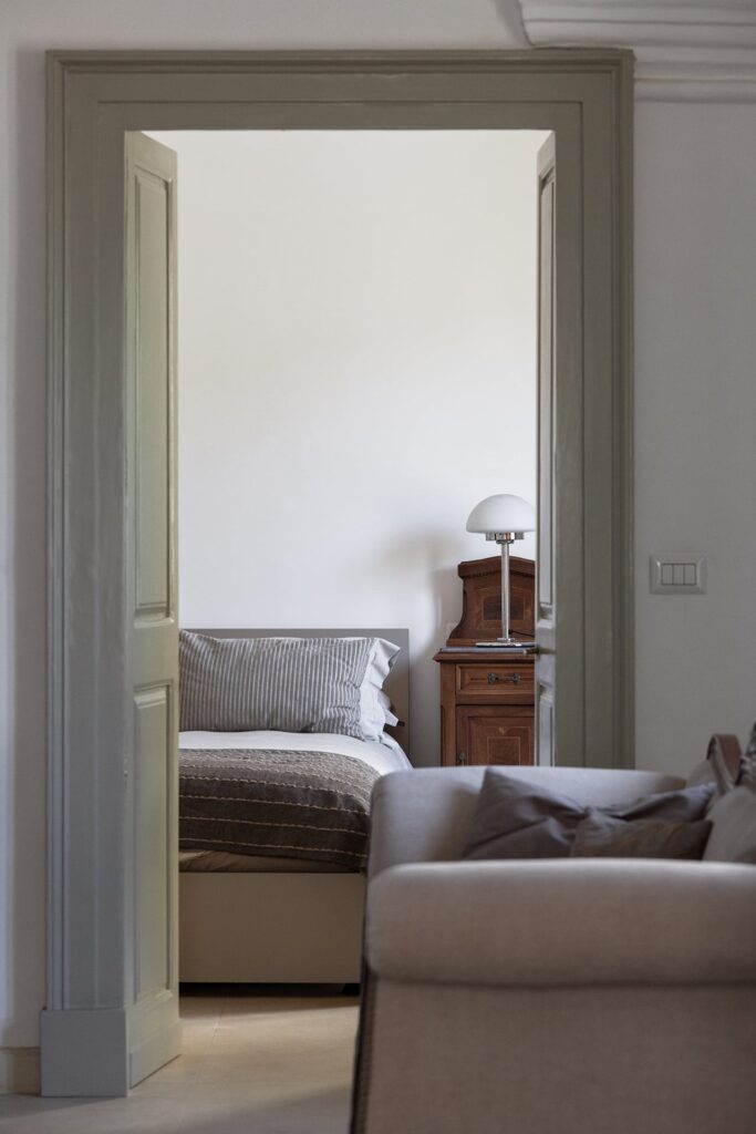 19. Angelo_Custode_Nardòsalento_Credits40Mirrors_01_Master bedroom Master bedroom seen through the living room doorway, Angelo Custode, Nardò