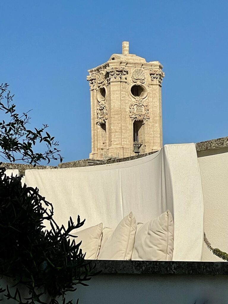 1bis Angelo Custode Terrace daybed with the baroque bell tower rising behind it, Angelo Custode, Nardò
