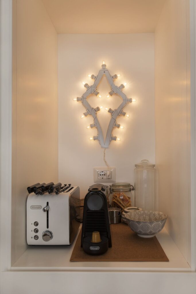 Kitchen nook with a decorative star light above the appliances, Teatro house, Nardò