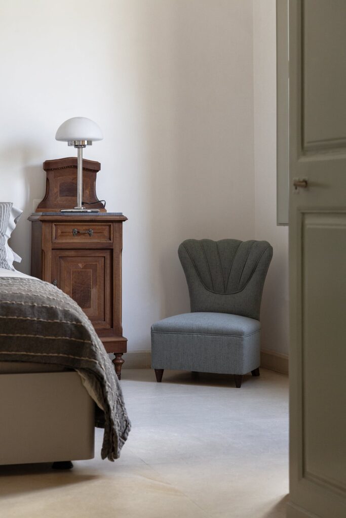 22.Angelo_Custode_Nardòsalento_Credits40Mirrors_02_Master bedroom Master bedroom detail with antique nightstand and scalloped chair, Angelo Custode, Nardò