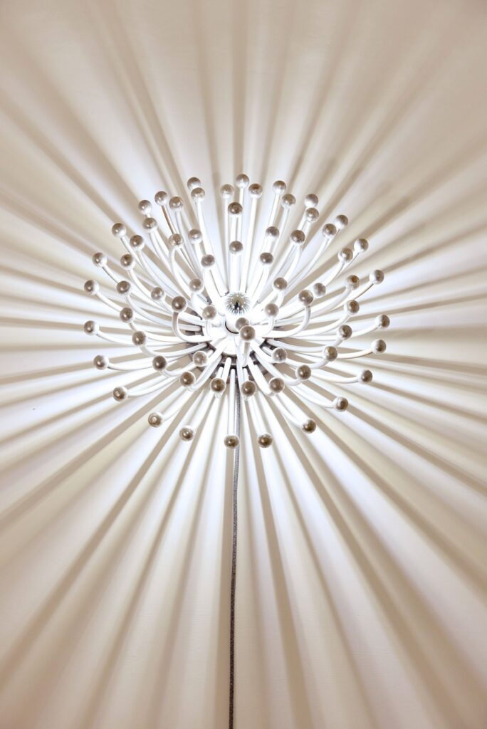 Starburst wall light detail in bedroom 4, La Corte palazzo, Nardò