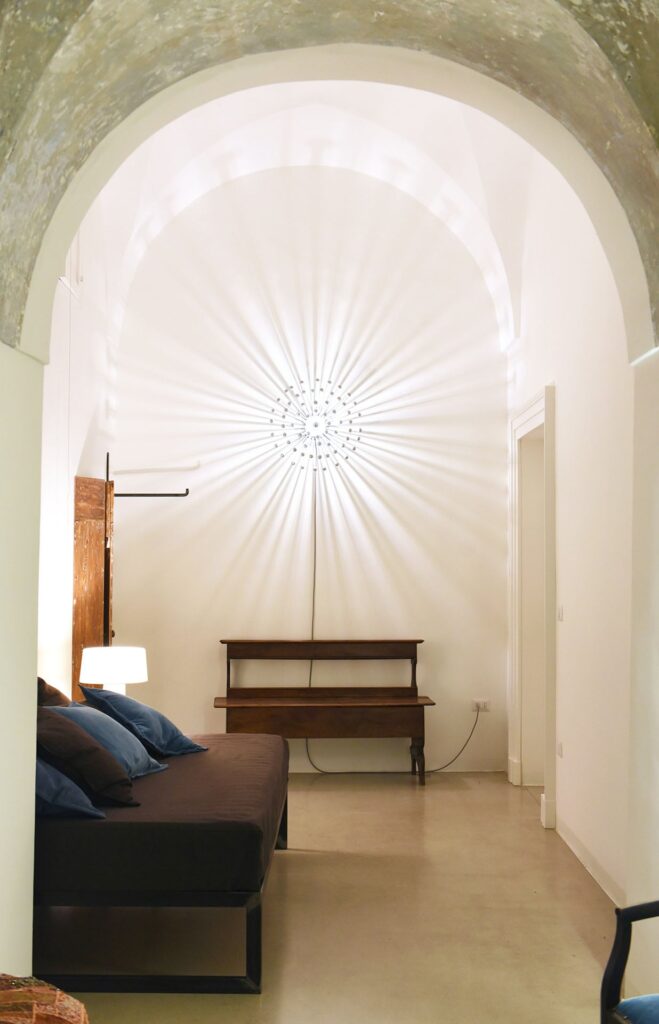 Bedroom 4 with vaulted ceiling and sculptural starburst wall light, La Corte, Nardò