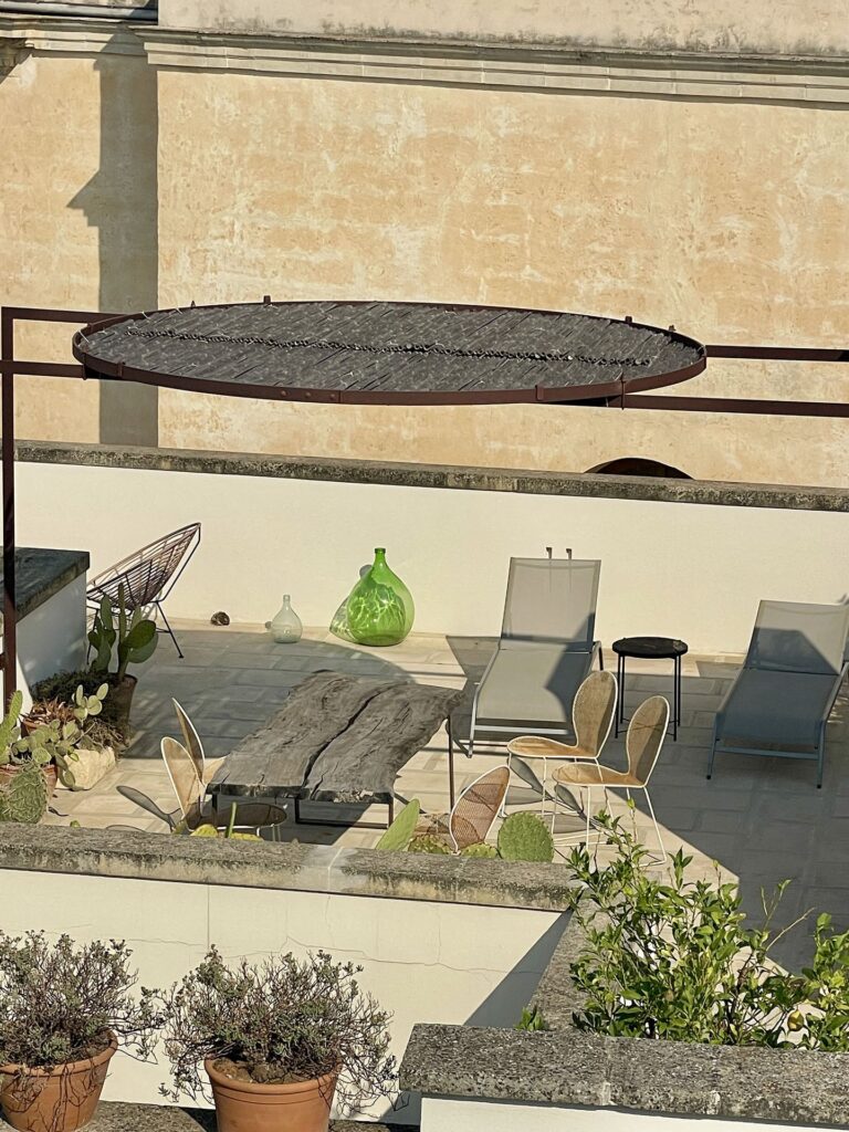 Rooftop terrace with sun loungers seen from an upper floor, Teatro house, Nardò