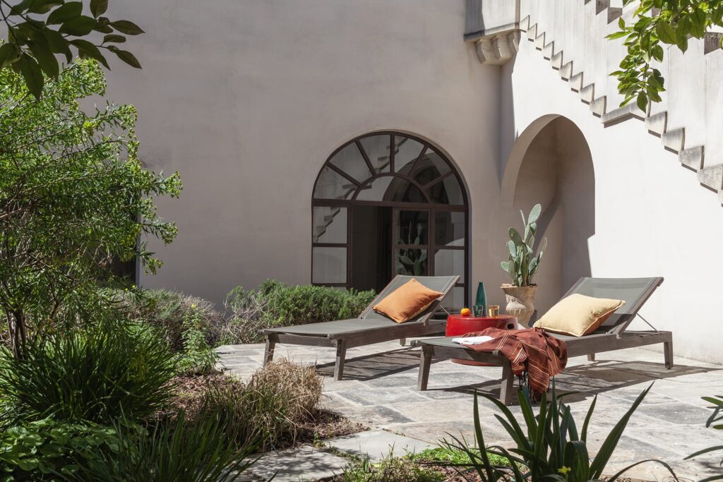 Garden lounge chairs beside the external staircase, Agrumeto house, Nardò