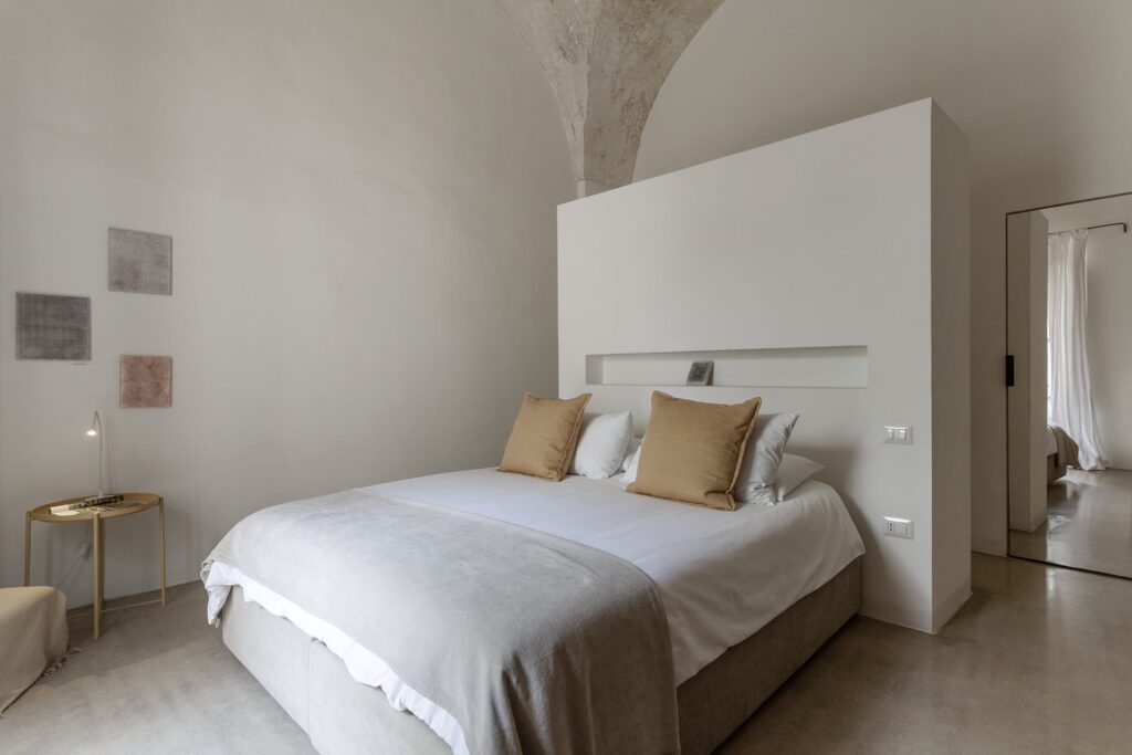 Bedroom 2 with minimalist headboard wall and vaulted ceiling, La Corte, Nardò