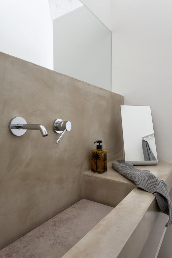 Bedroom 2 ensuite bathroom with wall-mounted taps and concrete sink, La Corte, Nardò