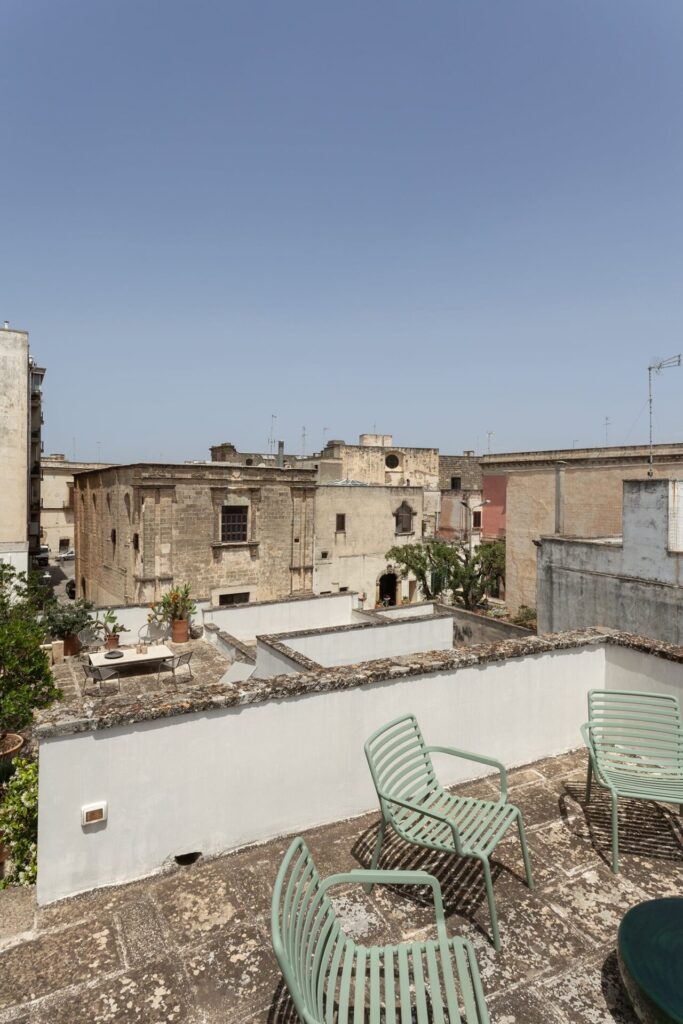 29. La_Corte_Nardòsalento_Credits40Mirrors_terrace_007_Upper terraces Upper terraces with sage green chairs overlooking Nardò's rooftops, La Casa Grande