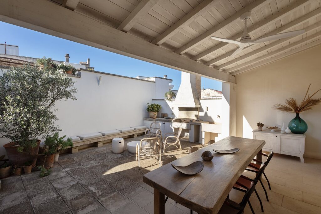 3. Angelo_Custode_Nardòsalento_Credits40Mirrors_56_Intermediate terrace and terrace shed and summer kitchen Terrace summer kitchen with chimney and wicker chairs, Angelo Custode, Nardò
