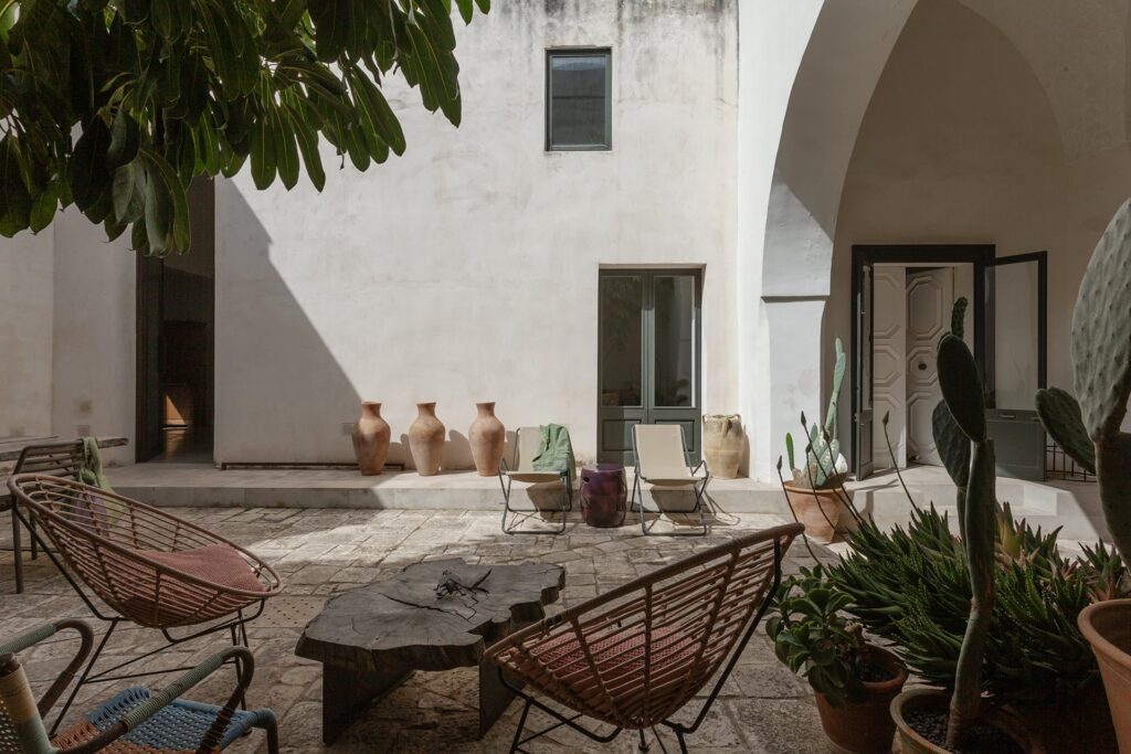 Courtyard seating area with terracotta jars beneath the loggia, La Corte, Nardò