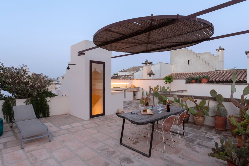 Rooftop terrace at dusk with dinner set beneath the pergola, Teatro, Nardò