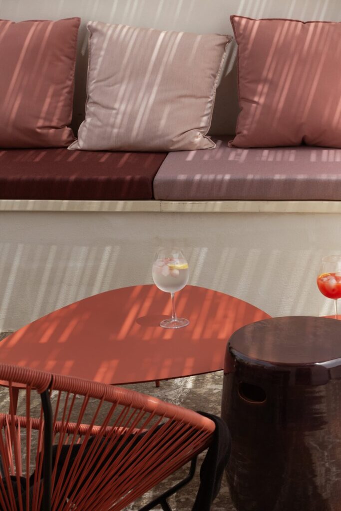 32. La_Corte_Nardòsalento_Credits40Mirrors_terrace_016_Rooftop lounge Rooftop lounge detail with striped cushions and drinks on the side table, La Casa Grande, Nardò