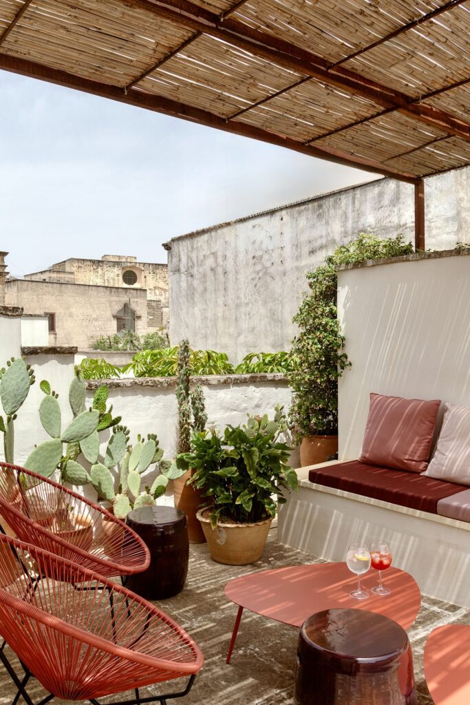 Rooftop lounge seating with cacti and a view over Nardò's rooftops