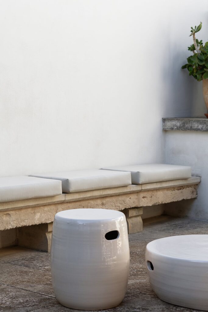 4. Angelo_Custode_Nardòsalento_Credits40Mirrors_95_Intermediate terrace detail Stone bench with cushions and ceramic garden stools, Angelo Custode terrace, Nardò