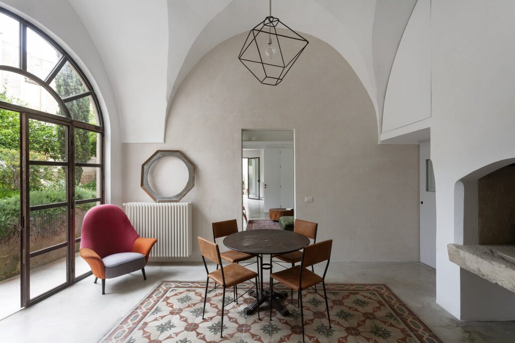 Vaulted dining hall with fireplace and garden doors, Agrumeto house, Nardò