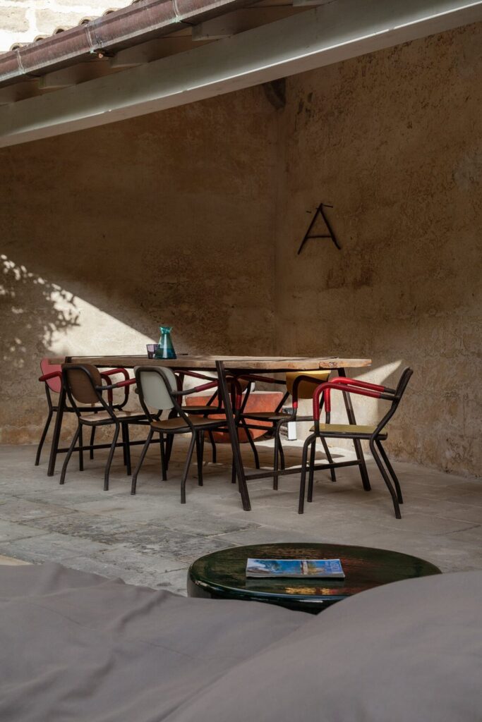 8 . Agrumeto_Nardòsalento_Credits40Mirrors_13_garden table Covered outdoor dining table beneath the old stone loggia, La Casa Grande, Nardò