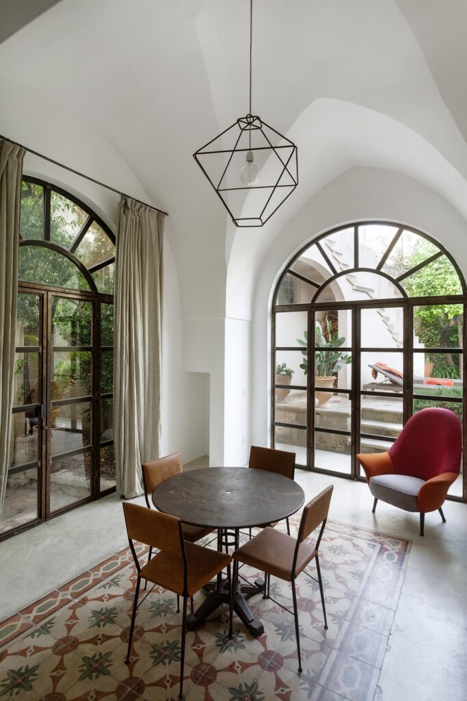 Hall and dining room with a geometric pendant light, Agrumeto house, Nardò