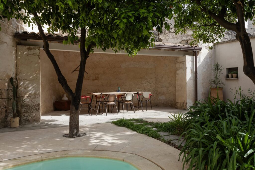 9 Agrumeto_Nardòsalento_Credits40Mirrors_05_shed Garden dining area beneath the citrus canopy, next to the pool, La Casa Grande, Nardò